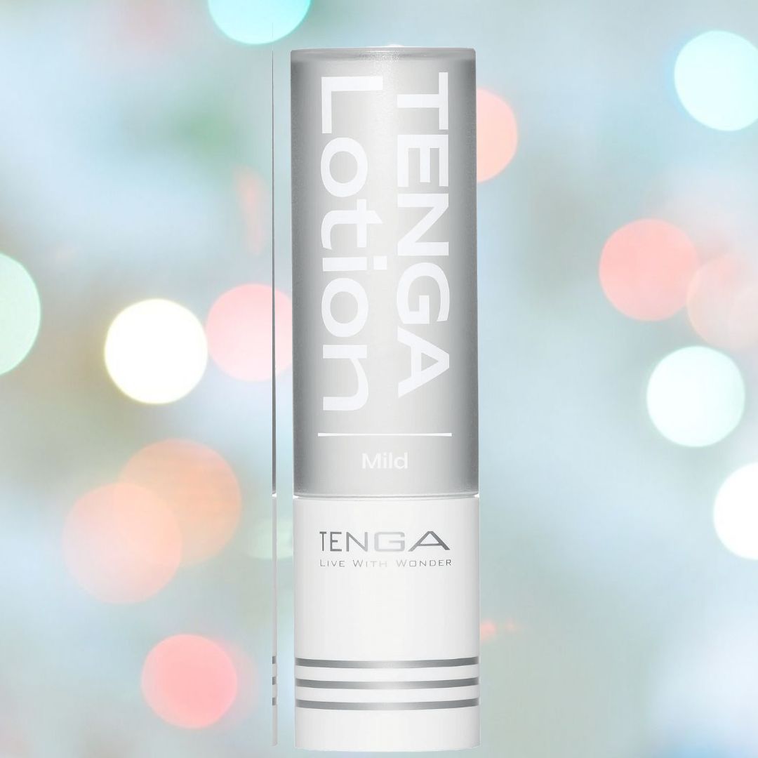 A cylindrical container in shades of gray and white, labeled "TENGA Hole Lotion 'Mild' Lubricant," stands upright. The background features a bokeh effect with soft, colorful circles of light, creating a gentle, festive atmosphere. This lubricant perfectly complements your Tenga toy experience with its soothing water-based formula.