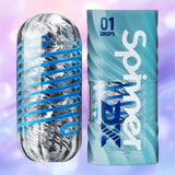 A transparent cylindrical Tenga Spinner DX 01 Drops by Tenga with a blue spiral is displayed beside its blue "Tenga Spinner DX 01 Drops" packaging, set against a soft, blurred pink, blue, and purple gradient.