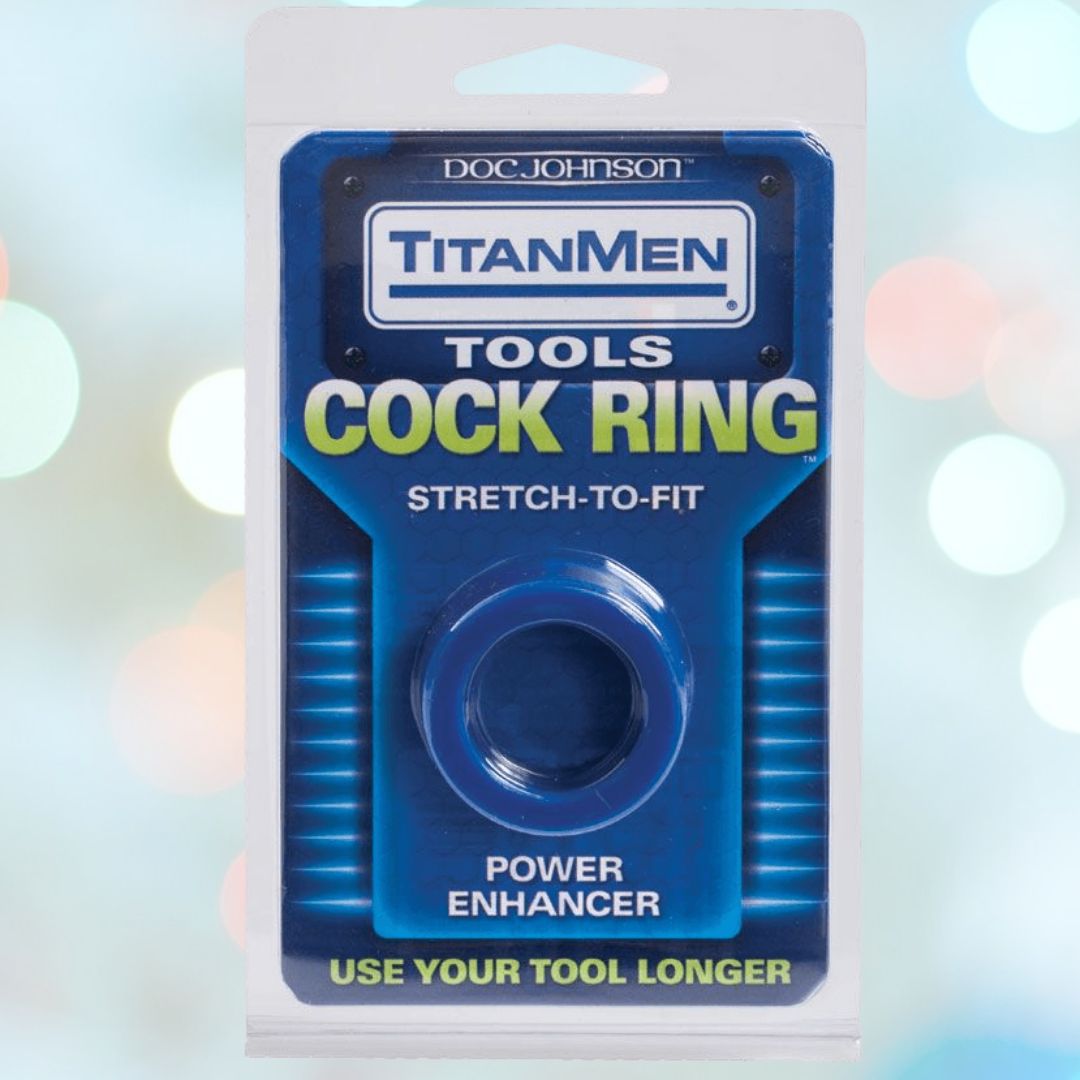 The image showcases the packaging of a Titanmen Stretch-to-Fit Blue Cock Ring by Doc Johnson. The text highlights features such as "Erection Enhancer," "Stretch-to-Fit," and "Use Your Tool Longer." The package is designed in blue with bold white text.