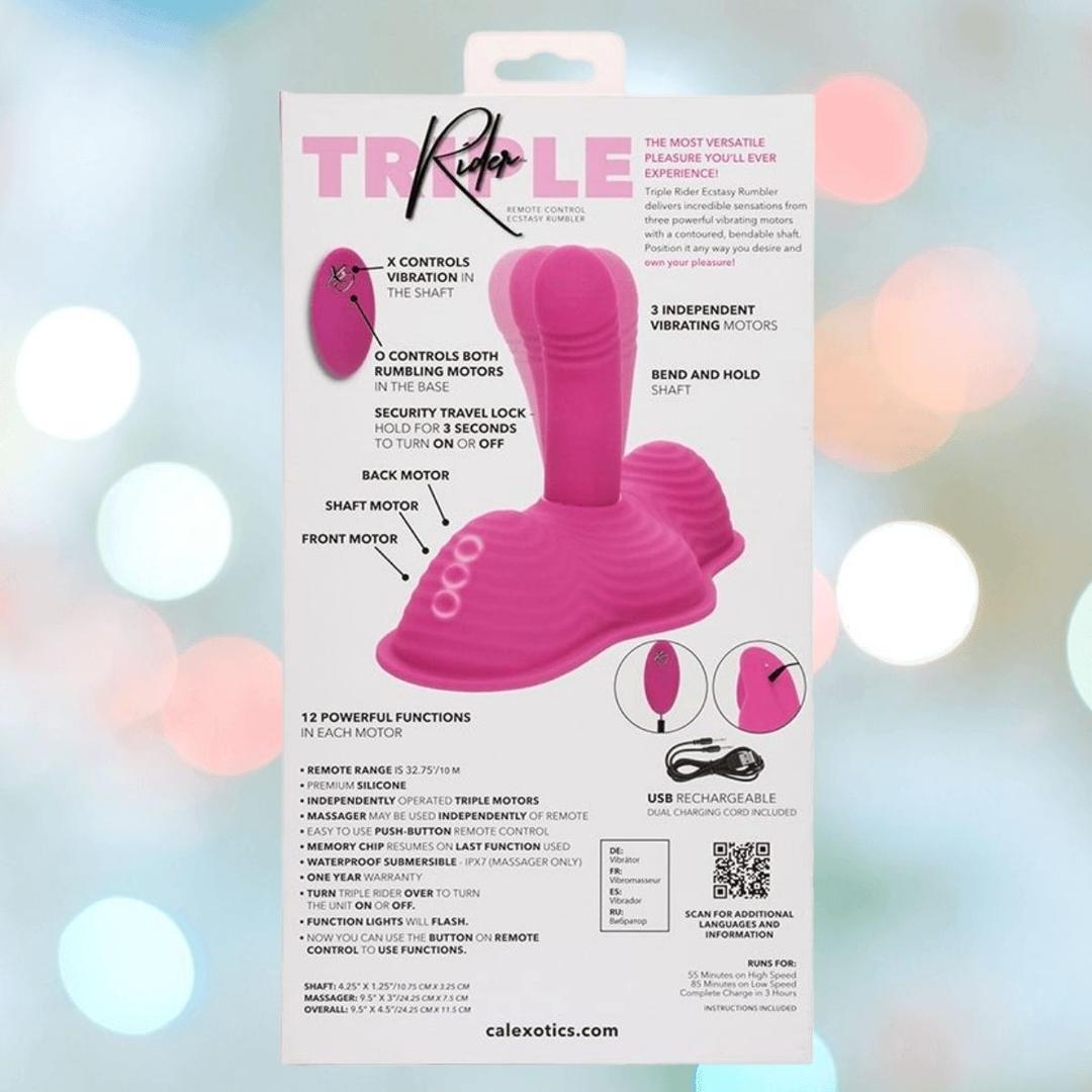 Packaging for the pink Triple Rider Remote Control Ecstasy Rumbler by CalExotics, featuring product highlights, remote control instructions, and USB rechargeability on a softly blurred light background.