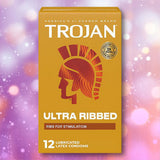 A box of Trojan Ultra Ribbed Condoms by Trojan, designed for added stimulation, featuring orange and yellow packaging with the helmet logo and “12 lubricated latex condoms” on a sparkly purple-pink background.