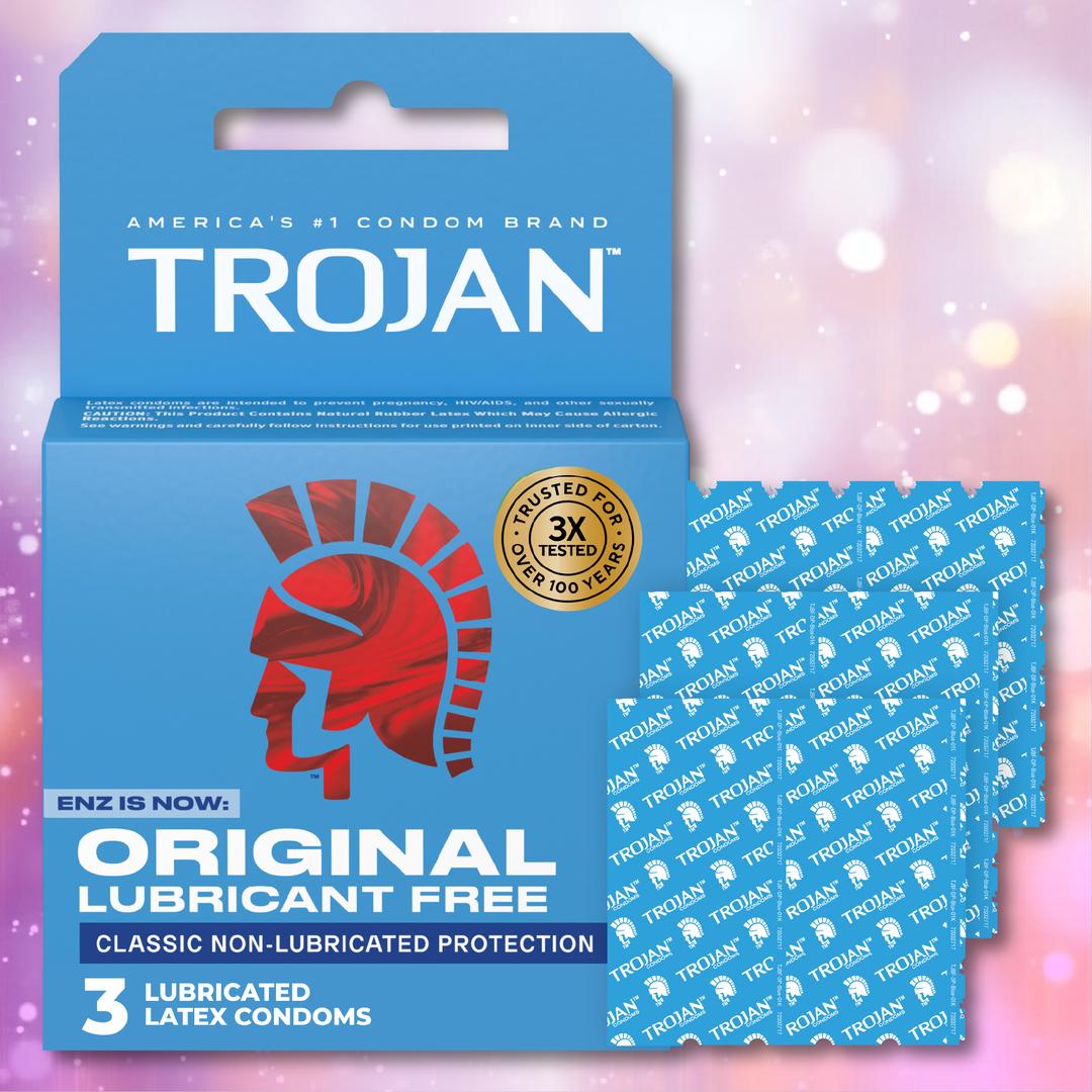 A blue box of Trojan ENZ Condoms Without Lube by Trojan is shown next to several individually wrapped, non-lubricated condoms. The packaging displays the red Trojan helmet and highlights "Lubricant Free" and "3 Latex Condoms.