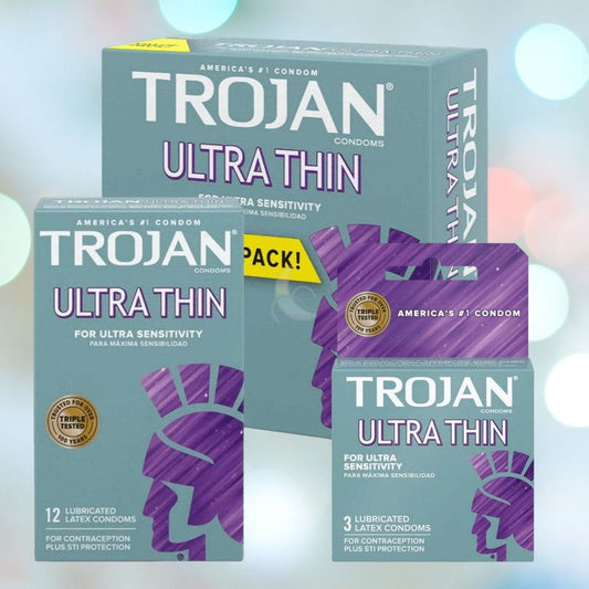 Image of three boxes of Trojan Ultra Thin Lubricated Condoms, showcasing the green and purple packaging that emphasizes their design for a natural feeling and increased sensitivity. They offer both contraception and STI protection. One box contains 12 condoms, another has 3, and the third is a value pack. 1080