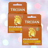 Two boxes of Trojan Charged Deep-Ribbed Condoms by Trojan sit side by side against a soft, blurred background. Each box contains three lubricated, ribbed condoms designed for enhanced pleasure.