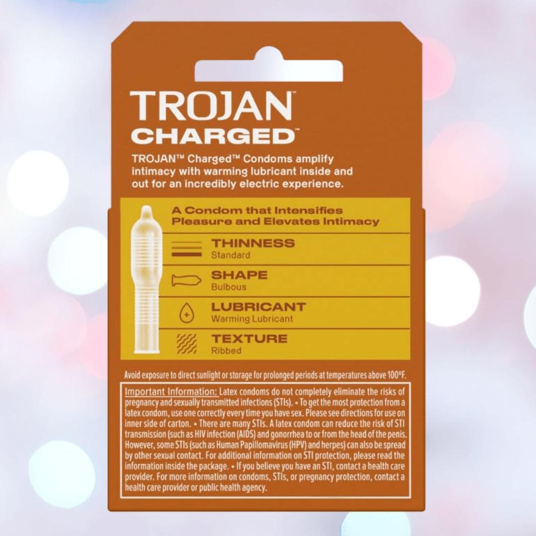 Package of Trojan Charged Deep-Ribbed Condoms by Trojan, featuring a thin design, bulbous shape, deep ribs, and warming lubricant, set against a blurred bokeh-lit background.