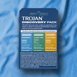 A Trojan Discovery Pack (3 Types of Condoms) from Trojan is displayed on blue fabric, showing details for Original, Ultra Thin, and Ultra Ribbed condoms, plus features and safety warnings on the packaging.