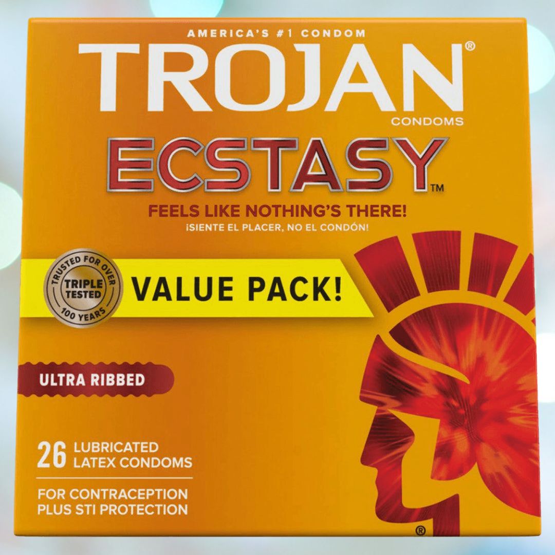 The bright orange Trojan Ultra Ribbed Ecstasy Condoms box prominently states "America's #1 Condom." The packaging highlights features like "Ultra Ribbed," "Value Pack!," and includes "26 lubricated latex condoms with premium lubricant." Designed for contraception and STI protection, it carries the slogan: "Feels like nothing's there!