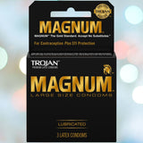 A three-pack of large Trojan Magnum Condoms from the brand Trojan features a stylish gold and black design. These lubricated condoms boast a comfort-fit shape for added ease, set against a background artfully blurred with vibrant lights to enhance their appeal.