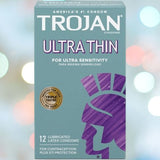 A box of Trojan Ultra Thin Lubricated Condoms is displayed. The teal box, featuring a purple Trojan helmet logo, highlights that these condoms are designed for increased sensitivity and a natural feeling. Lubricated latex ensures comfort, and the pack of 12 condoms offers both contraception and STI protection.