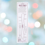 A product diagram and description for the Tryst Duet Double-Ended Silicone Vibrating Dildo with Wireless Remote - Berry by Doc Johnson, shown on a blurred pastel background, with text and illustrations highlighting its features and controls.