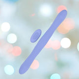 The Doc Johnson Tryst Duet Double-Ended Silicone Vibrating Dildo in Periwinkle, featuring a flexible design and a matching wireless remote, is displayed against a softly blurred pastel background.