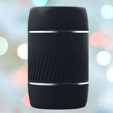 A VeDO Jerk Masturbation Sleeve in black, featuring a clear sleeve, is displayed against a blurred background of colorful bokeh lights.