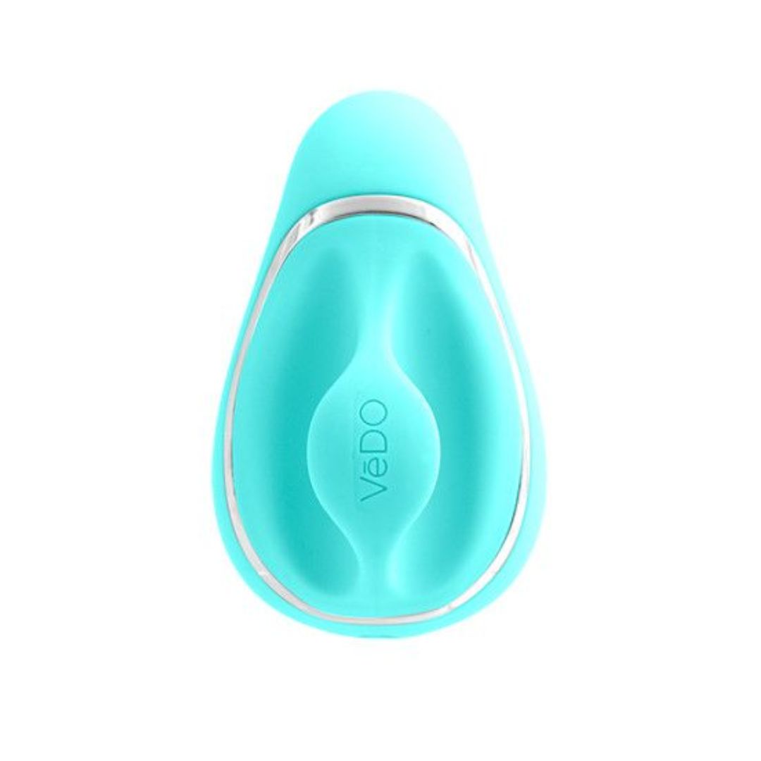 An image of the VeDO Suki - Turquoise Air Suction Clit Stimulator showcases a bean-shaped object with a silky-smooth silicone surface and slight indentations. It bears the brand name "VeDO" on its front and features a metallic accent running along its sides, enhancing its sleek design.