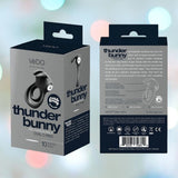 The packaging for VeDO's "Thunder Bunny" Dual Cock Ring in Black Pearl is showcased. The label emphasizes its powerful vibrations with ten dynamic modes. The box includes a product image and detailed instructions, highlighting the rechargeable dual C-ring's distinctive design.