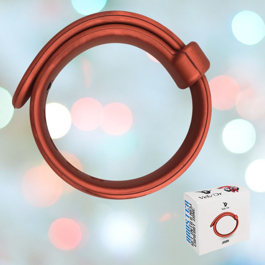 A red Velv'Or Rooster Jason Adjustable Hard Silicone Cock Ring with a smooth, modern strap design floats against a background of soft pastel bokeh lights. Below, a small box showcases the product's image and Velv'Or brand logo, highlighting its sleek features.