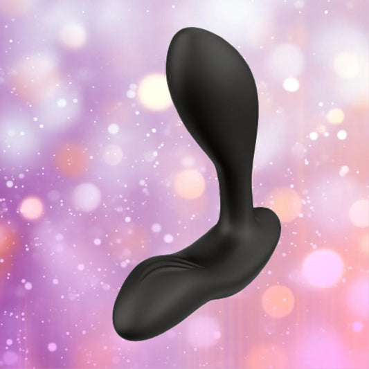 The We-Vibe Vector+ Vibrating Prostate Massager in Charcoal Black by We-Vibe is shown against a blurred background with pink, purple, and white bokeh lights, highlighting its curved design for powerful prostate stimulation. 1080