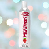 A bottle of Wet Delicious Oral Play Strawberry flavored lubricant is displayed against a vibrant, blurred backdrop of colorful lights. It features 4 fl. oz. (118 ml) of enticing lubricant for enjoyable moments.