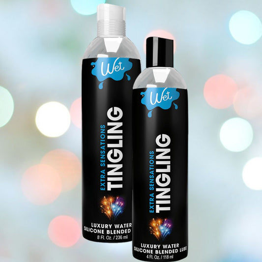 Two bottles of Wet Extra Sensations Tingling Water/Silicone Blend Based Lubricant by Wet (8 fl oz & 4 fl oz) show black labels with blue-white accents on a pastel bokeh background. The hybrid formula includes cooling peppermint extract. 1080
