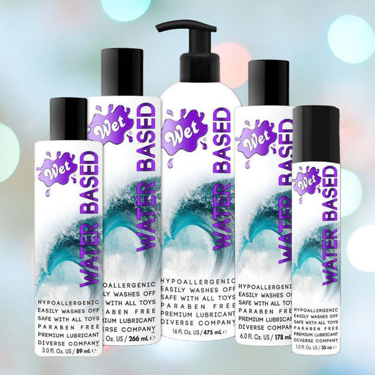 A collection of Wet Original Gel Water-Based Lubricant bottles in various sizes, set against a light background. The bottles display a splash design with purple accents, and the labels emphasize that the product is hypoallergenic, paraben-free, and compatible with sex toys. 1080