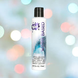 A bottle of Wet Original Gel Water-Based Lubricant stands against a blurred background of colorful lights. The bottle is white with a black cap and features text highlighting it as hypoallergenic, paraben-free, and compatible with all sex toys.