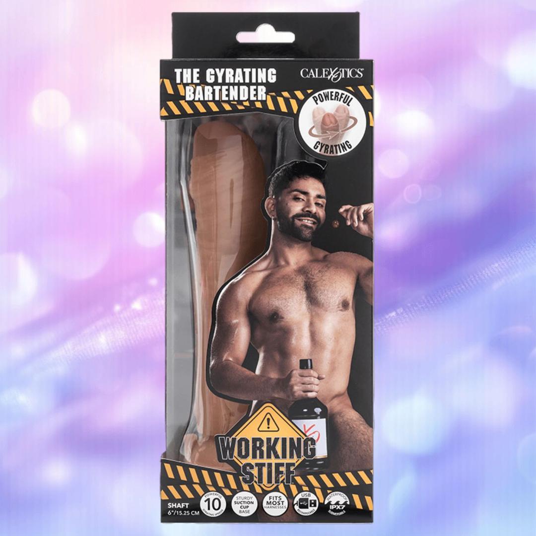The CalExotics Working Stiff The Gyrating Bartender box shows a realistic dildo with powerful movement, plus an image of a smiling bearded man with a bottle against a vibrant purple and blue background.
