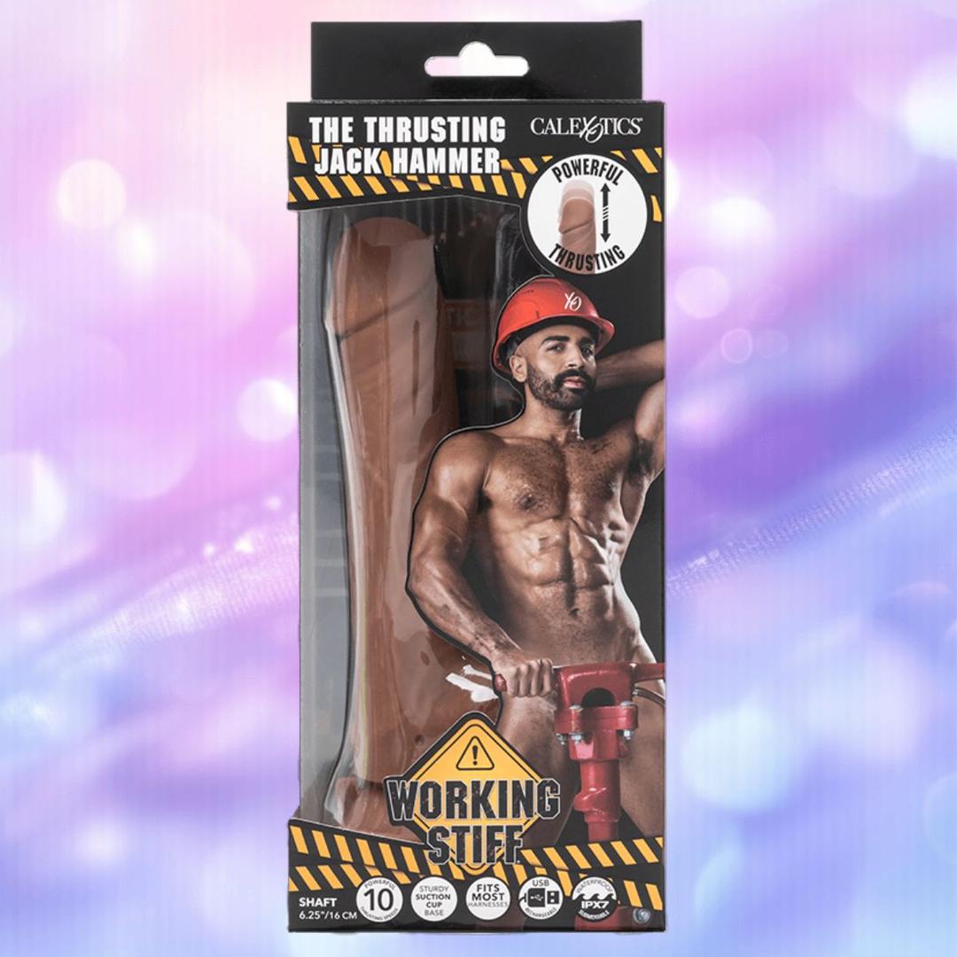 Box packaging for CalExotics "Working Stiff The Thrusting Jack Hammer" shows a muscular, shirtless man in a construction helmet with a jackhammer, bold construction-style graphics, and the toy visible inside.