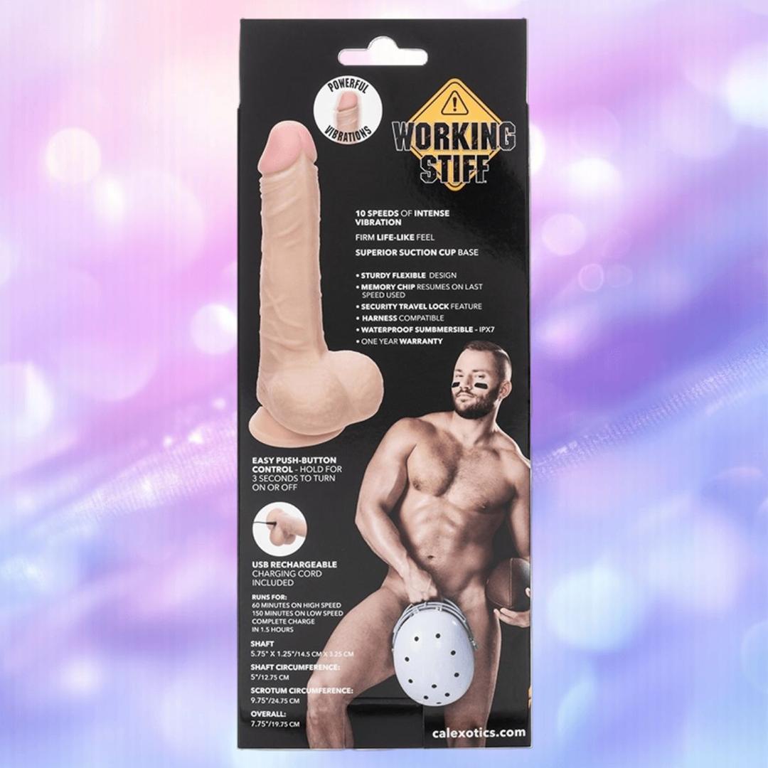 The CalExotics Working Stiff The Vibrating Quarterback Dildo comes in packaging showing a lifelike dildo and a muscular, bearded man in a harness. Features include remote-controlled vibration, suction cup base, and waterproof design.