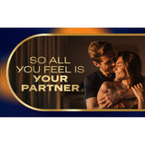 A smiling couple embraces in soft lighting beneath the bold text "So all you feel is your partner." Curved gold and dark blue lines in the background evoke the comfort of Durex Intense Nitrile XL (Non-Latex) Condoms by Durex.