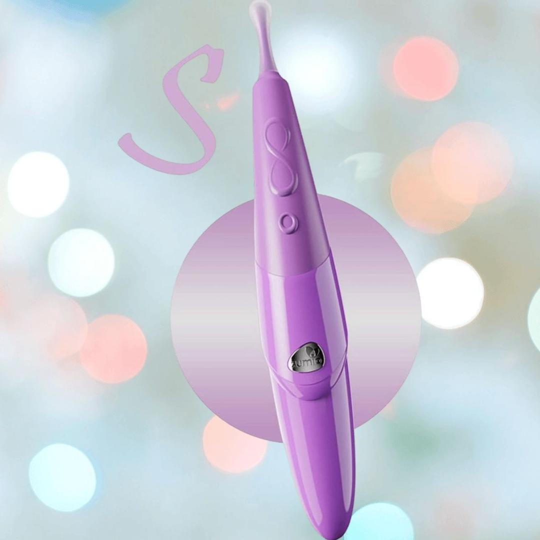 The Zumio S Spirotip Clitoral Stimulator - Light Purple by ZUMIO, INC stands upright against a blurred pastel background, its rounded tip and precise stimulation features highlighted by soft bokeh lights.