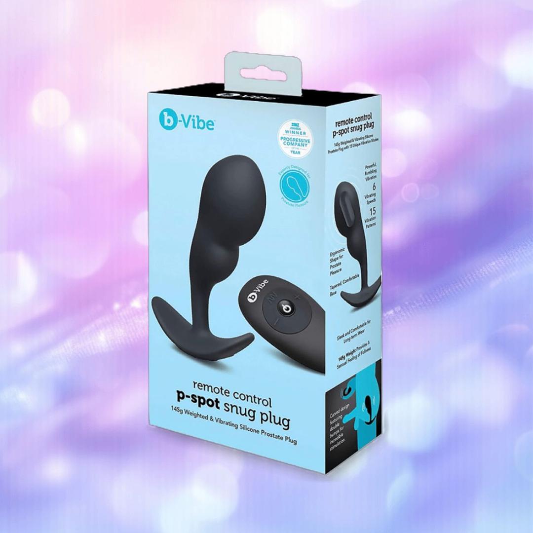 A B-Vibe Vibrating P-Spot Snug Plug RC Large box showcases the plug and its remote, featuring a purple and blue gradient background with soft, blurry light spots.