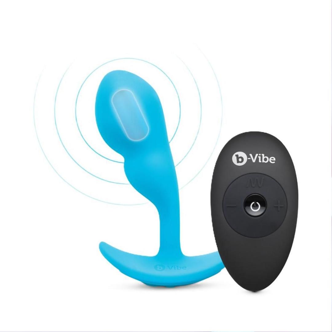 The B-Vibe Vibrating Snug Plug RC: Silicone P-Spot Anal Vibrator - Small, shown in blue with a flared base beside its black "b-Vibe" remote, offers hands-free anal pleasure and precise stimulation on a white background.