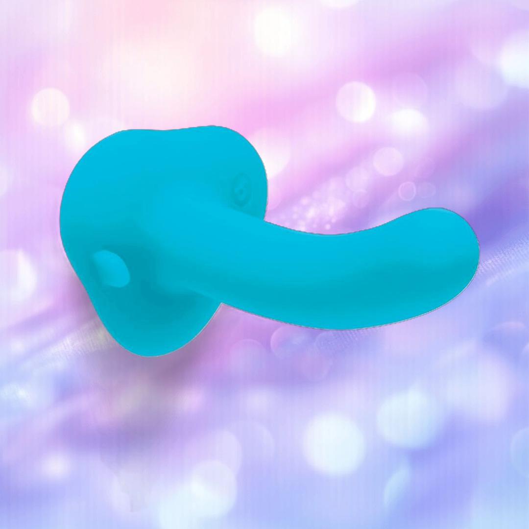 The B-Vibe Every Body Strap-On Harness Set with 6" Silicone Dildo is displayed center stage against a soft, pastel purple and pink bokeh background.