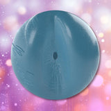 A spherical blue Fleshjack Boys Reno Gold: Realistic Male Masturbator Cake Butt BIRTHDAY EDITION toy with a textured internal surface, a centered circular opening, and embossed cursive writing on the side.