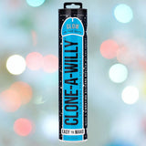 A blue cylindrical package labeled "Clone-A-Willy Glow in the Dark - Blue" from Empire Labs, featuring "Glow in the Dark" at the top and "Easy to Make" at the bottom, set against a bokeh background with colorful, blurred circular lights. This kit by Empire Labs allows you to create a personalized glow-in-the-dark dildo.