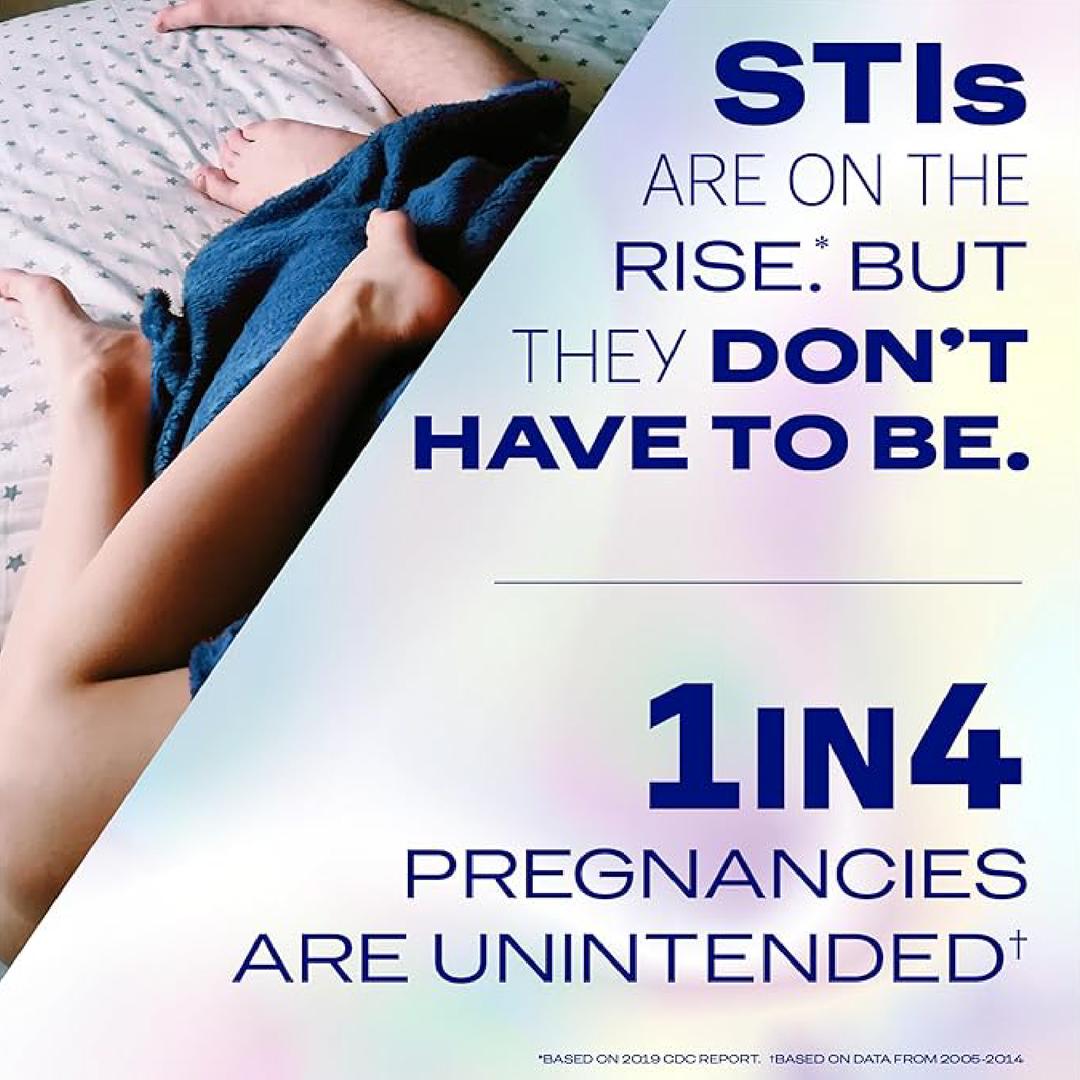 A couple lies in bed under a blue blanket. Bold text reads: "STIs are on the rise, but they don't have to be. 1 in 4 pregnancies are unintended. Choose protection that fits your needs—Durex Air Large Wide Fit Condoms by Durex offer ultra-thin, safe comfort without compromise.