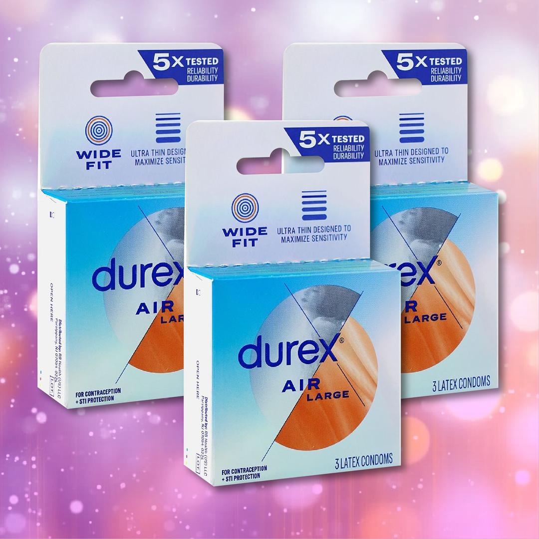 Three boxes of Durex Air Large Wide Fit Condoms by Durex are displayed against a pink and purple bokeh background. The packaging highlights features such as “ultra thin” and “wide fit.”.