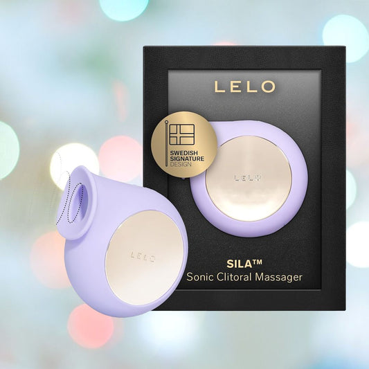 Introducing the LELO SILA Air Suction Clit Massager in Lilac. This refined device, crafted by the renowned LELO brand for clitoral stimulation, showcases a gentle lilac hue with elegant gold accents. The packaging highlights its Swedish signature design against a softly blurred pastel backdrop, amplifying its sophistication. 1080