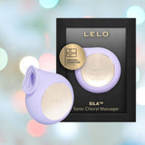 Introducing the LELO SILA Air Suction Clit Massager in Lilac. This refined device, crafted by the renowned LELO brand for clitoral stimulation, showcases a gentle lilac hue with elegant gold accents. The packaging highlights its Swedish signature design against a softly blurred pastel backdrop, amplifying its sophistication.