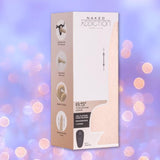 A beige and white box for the BMS Naked Addiction Thursting Dong - Vanilla 8.5" displays images and icons for features like magnetic charging, remote control, and a strong suction cup, set against a purple bokeh background.