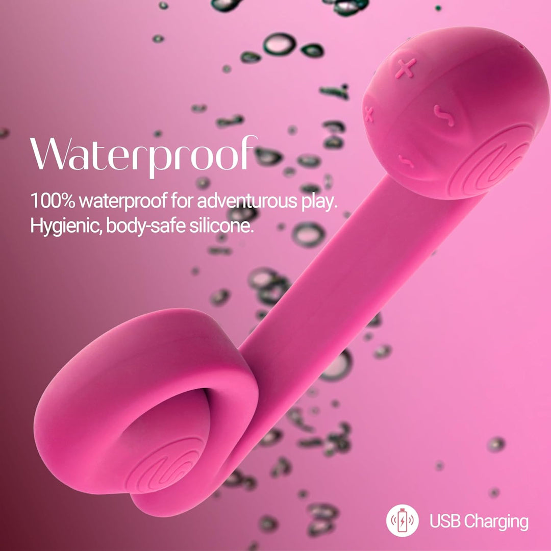 Image of the Snail Vibe Dual-Motor Thrusting Vibrator (Pink) by Snail Vibe, featuring a curved silicone design with a ring at one end and a textured ball at the other, ideal for clitoral stimulation. Text reads, "100% Waterproof for adventurous play. Hygienic, body-safe silicone." Icons indicate USB charging capability. Background features water droplets.