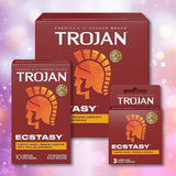 Three boxes of Trojan Ultra Ribbed Ecstasy Condoms by Trojan are shown against a sparkling purple background, featuring red packaging with a gold Trojan helmet and text emphasizing ribbed texture and premium lubrication.