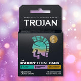 The Trojan Bareskin EveryTHIN Pack (Variety Pack) by Trojan contains 3 lubricated latex condoms—1 Raw, 1 BareSkin, and 1 BareSkin Thin—in a sleek black box with a holographic helmet logo and vibrant lights background.