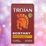 A box of Trojan Ultra Ribbed Ecstasy Condoms by Trojan is centered on a blurred, multicolored background. The maroon packaging shows a gold Trojan helmet and highlights premium lubricant and ribbed design for added comfort.