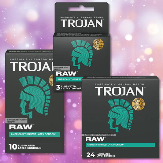 Three boxes of Trojan Raw Ultra-Thin Condoms, branded as Trojan, offer a natural feel. Available in 3, 10, and 24 count boxes with teal helmet logos on a pink and purple bokeh background. 1080