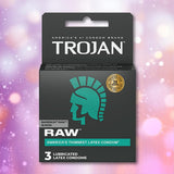 A box of Trojan Raw Ultra-Thin Condoms by Trojan, featuring teal and white text and the Trojan helmet logo, rests against a blurred pastel background. The box contains 3 lubricated condoms.