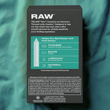 A box of Trojan Raw Ultra-Thin Condoms by Trojan sits on a teal fabric surface, its packaging emphasizing a straight shape, silky smooth lubricant, and durable latex material.