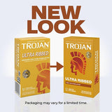 Two boxes of Trojan Ultra Ribbed Condoms are side by side, with an arrow from the old design on the left to the new lubricated latex condoms packaging on the right. Text above says "NEW LOOK." Brand: Trojan.