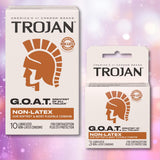 Two boxes of Trojan G.O.A.T. Non-Latex Lubricated Condoms from Trojan, featuring ultra flex comfort, are displayed against a purple and pink bokeh background. Each box displays a bronze Trojan helmet logo.