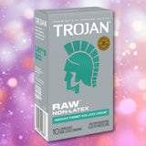 A box of Trojan Raw Non-Latex Condoms from Trojan, featuring a teal helmet logo and bold lettering highlighting "non-latex" and "America’s thinnest non-latex condom," displayed on a soft purple background with subtle bokeh effects. Made from polyurethane, these condoms provide an ultra-thin, sensitive option for those seeking non-latex protection.