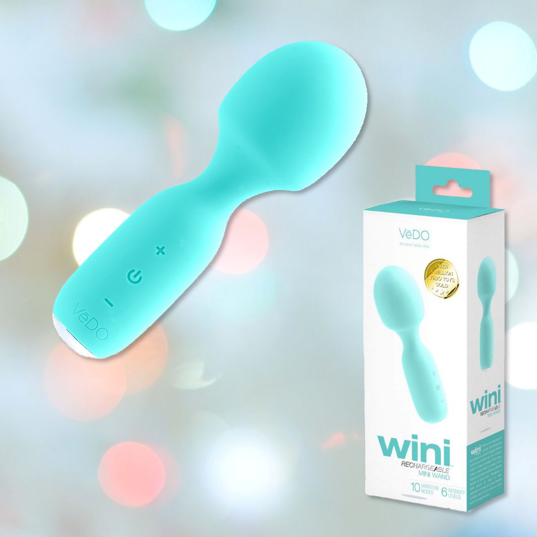 The image features the turquoise-colored VeDO WINI Mini Vibrator Wand, floating beside its packaging. Softly blurred pastel lights fill the background, creating a calming atmosphere. Both the massager and its box prominently display the brand name VeDO and highlight its 10 vibration modes.